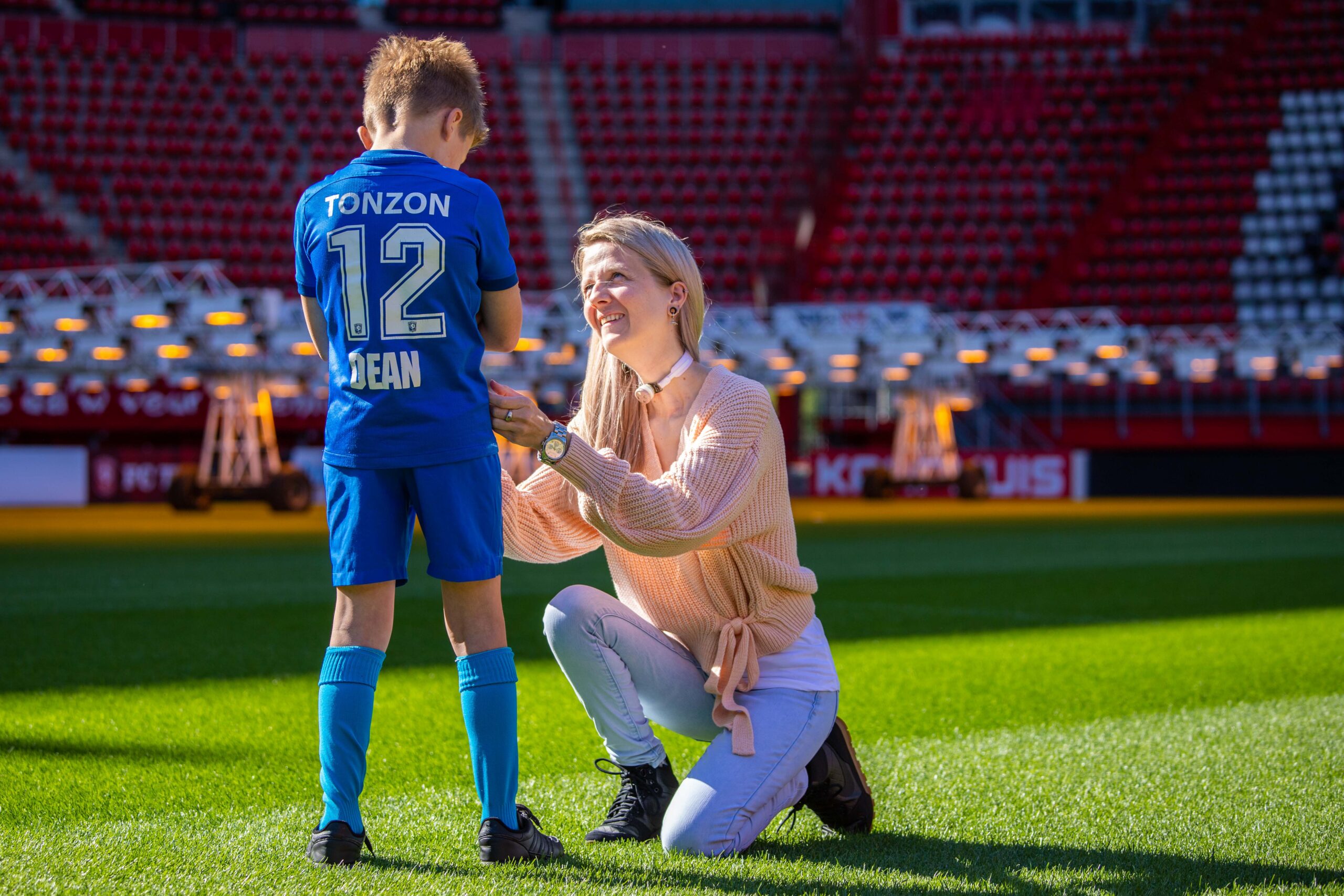 woman using freevent dualcare helping child on football field